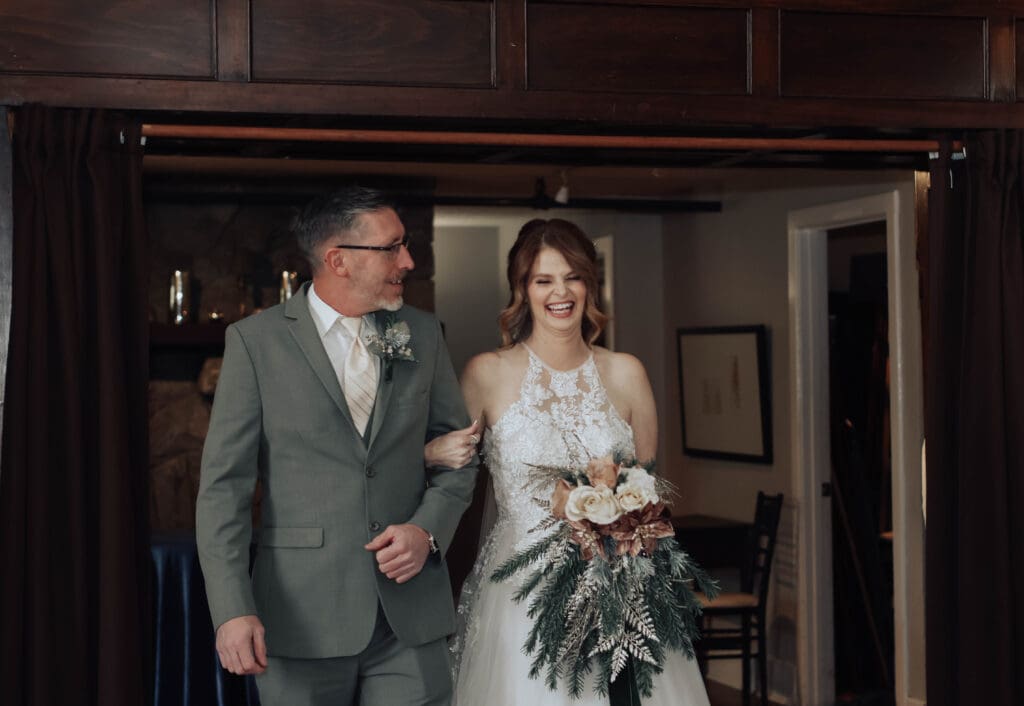 A bride and groom laugh while they walk into their ceremony for their Asheville Elopement