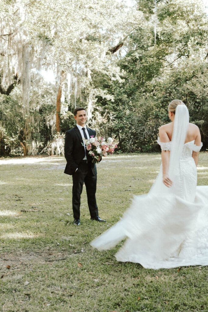 An eloping bride shows her wedding dress to her groom in a South Carolina Park 
