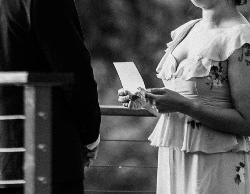A black and white photo of a bride reading her vows at this Greenville, SC elopement.